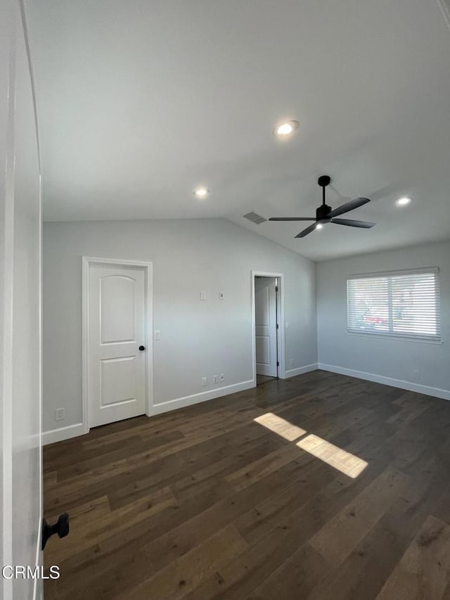 spare room with lofted ceiling, ceiling fan, and dark wood-type flooring