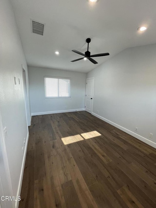 unfurnished room with ceiling fan, dark wood-type flooring, and lofted ceiling