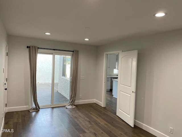 empty room with dark hardwood / wood-style floors