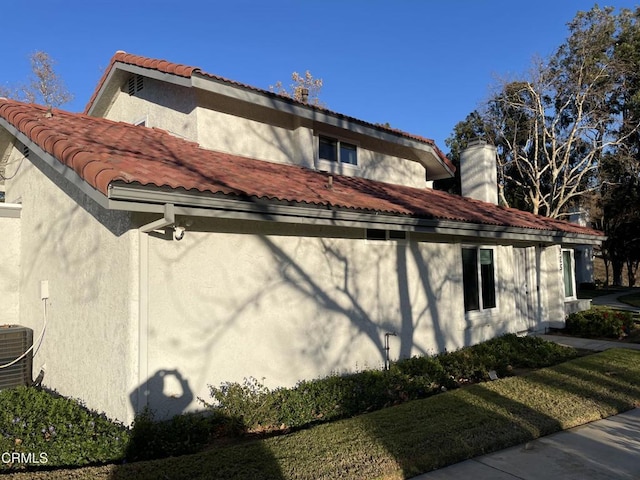 view of side of home with a lawn