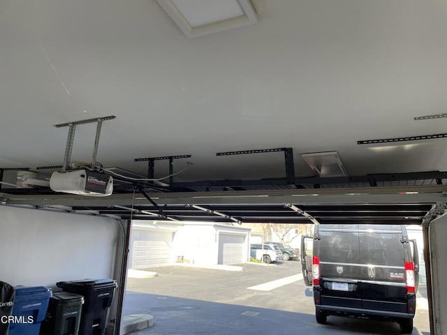 garage with a garage door opener and a carport