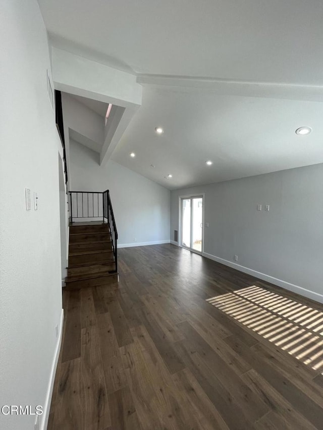 interior space featuring dark hardwood / wood-style floors and vaulted ceiling with beams