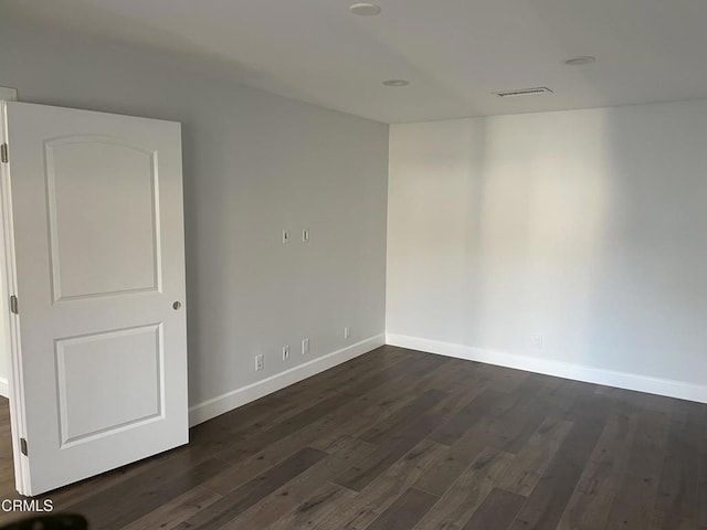 unfurnished room featuring dark hardwood / wood-style floors