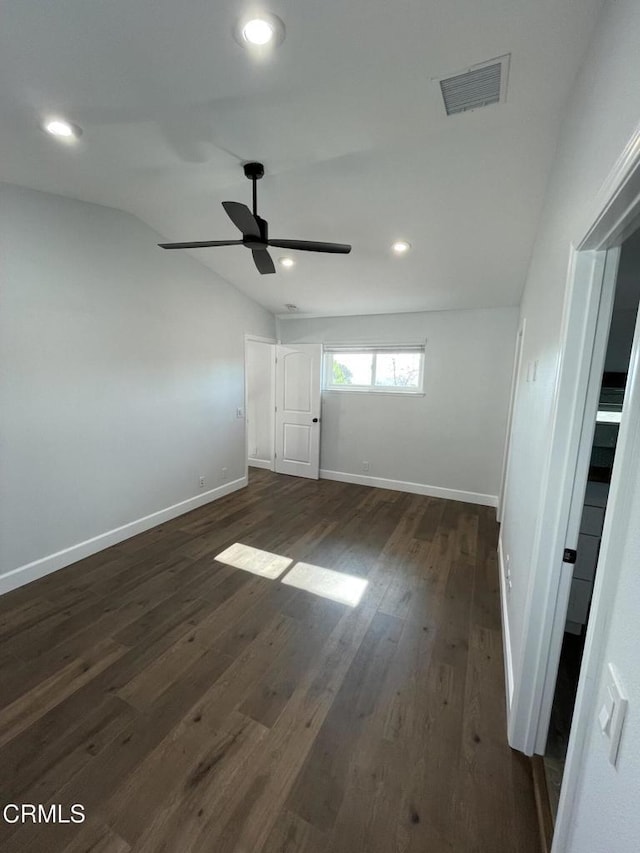 spare room with ceiling fan, dark hardwood / wood-style flooring, and lofted ceiling