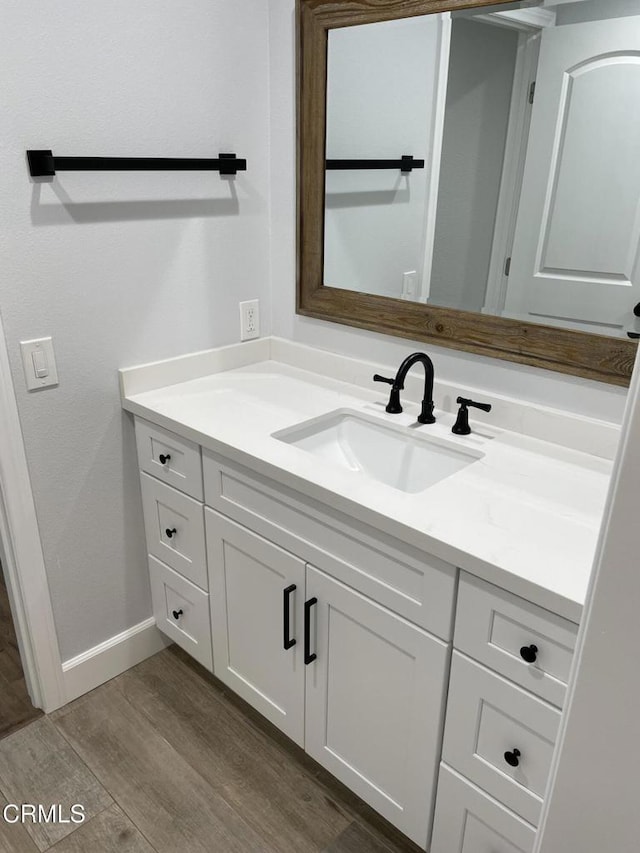 bathroom with vanity and hardwood / wood-style floors