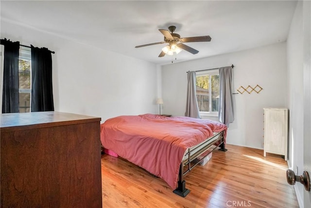 bedroom with ceiling fan and light hardwood / wood-style floors