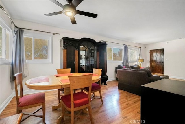 dining area featuring ceiling fan and light wood-type flooring