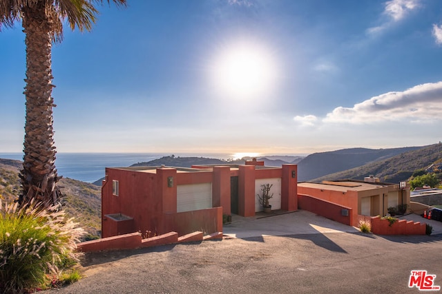 view of front facade featuring a mountain view and a garage