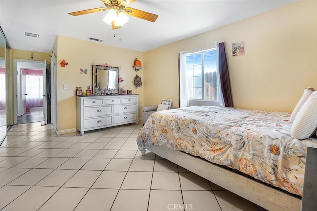 tiled bedroom featuring ceiling fan