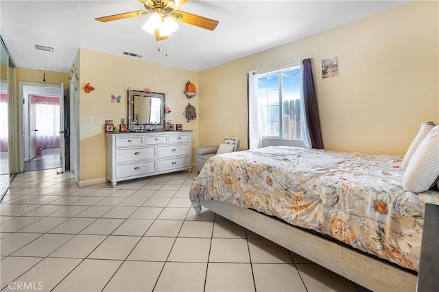 tiled bedroom with ceiling fan