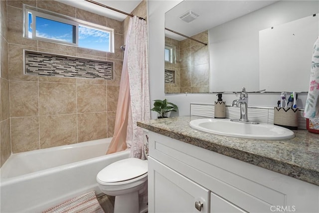 full bathroom with vanity, toilet, and shower / bath combo with shower curtain