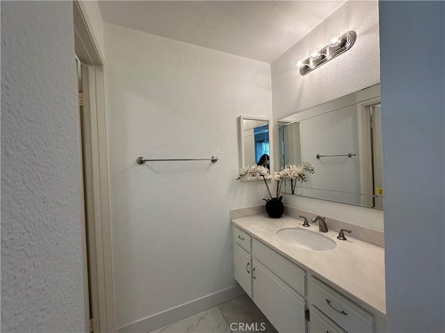 bathroom with vanity and a textured ceiling