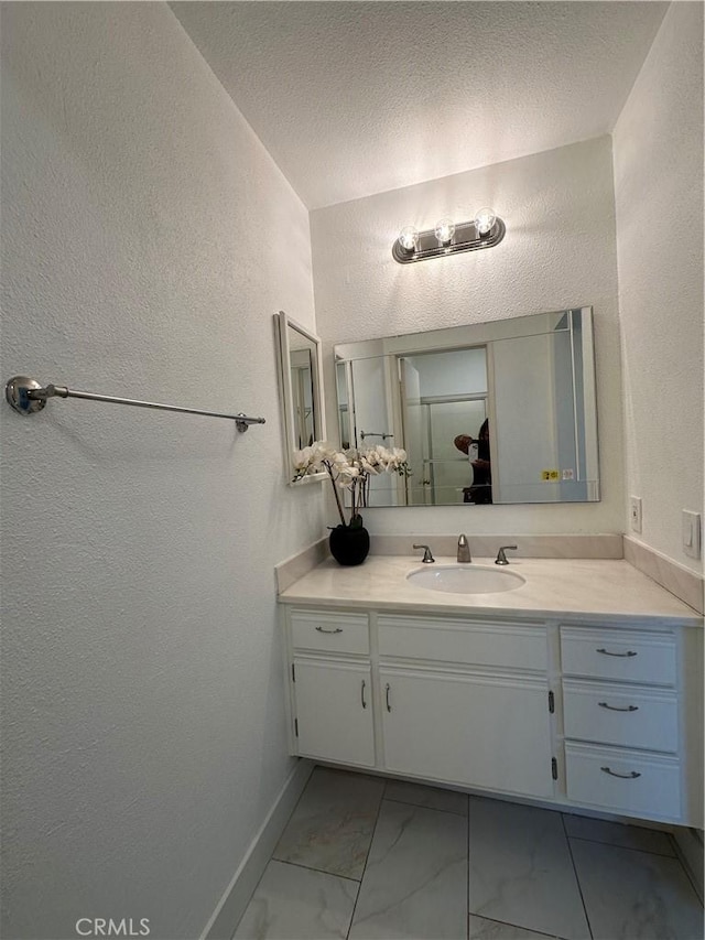 bathroom featuring vanity and a textured ceiling