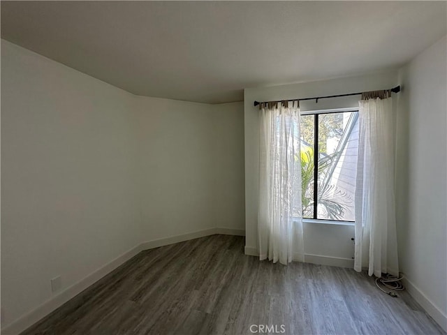 unfurnished room featuring dark wood-type flooring