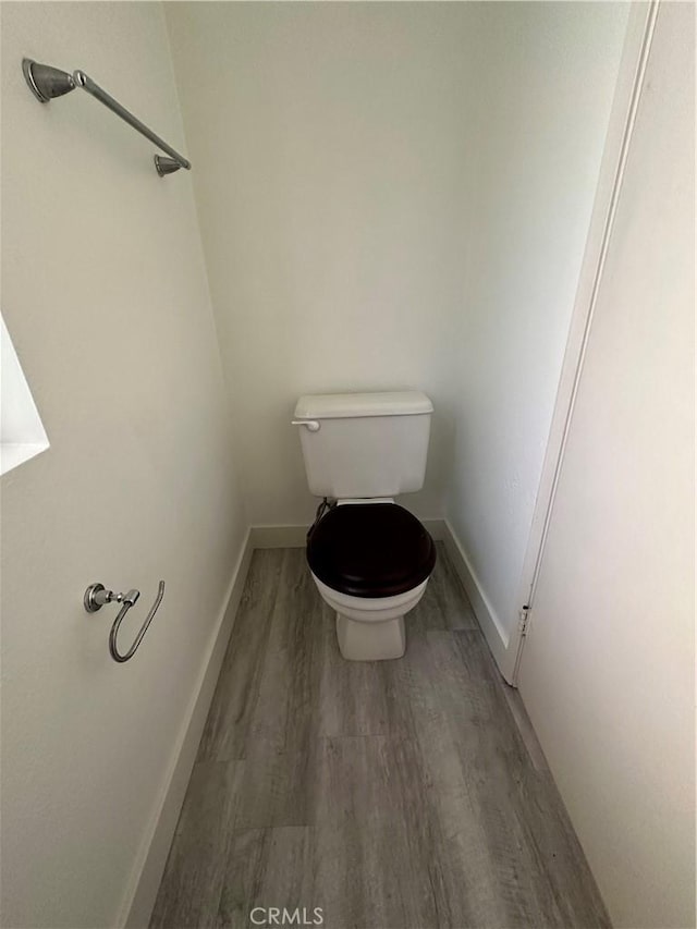 bathroom featuring toilet and hardwood / wood-style floors