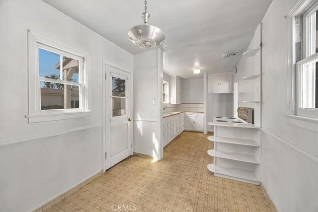 unfurnished dining area with a healthy amount of sunlight