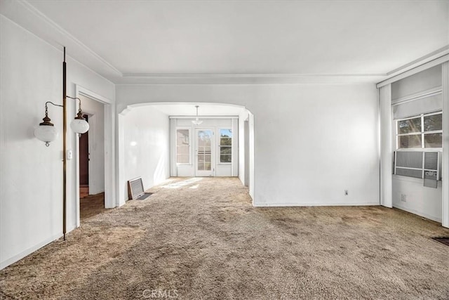 unfurnished room with ornamental molding, carpet, cooling unit, and french doors