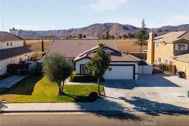 view of front of house with a mountain view, a front lawn, and a garage