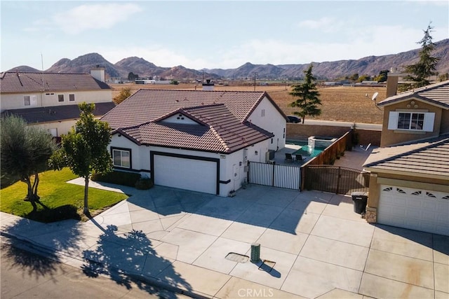 view of front facade with a mountain view and a garage