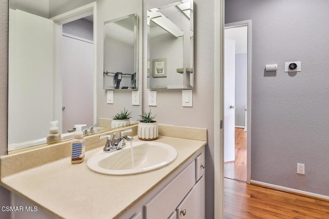 bathroom featuring vanity and wood-type flooring