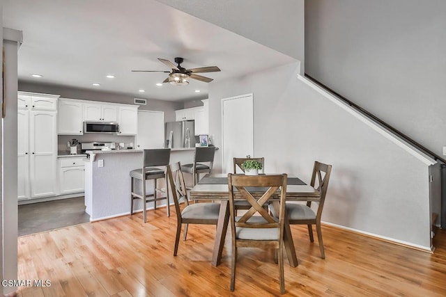 dining room featuring ceiling fan and light hardwood / wood-style flooring