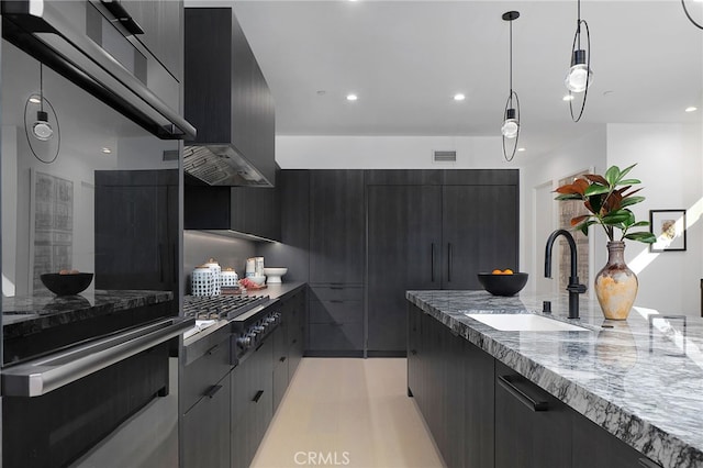 kitchen with ventilation hood, sink, hanging light fixtures, light stone counters, and stainless steel appliances