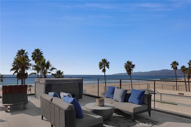 view of patio / terrace with an outdoor living space, a water and mountain view, and a balcony