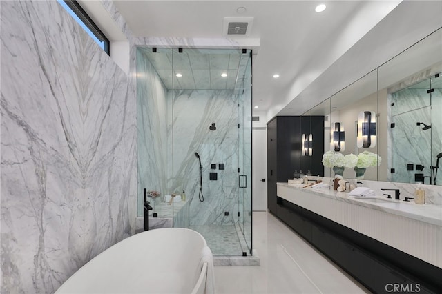 bathroom with vanity and separate shower and tub