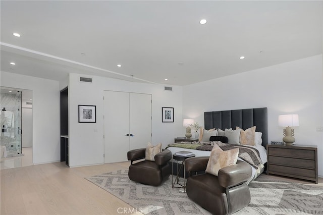 bedroom featuring light hardwood / wood-style flooring and a closet