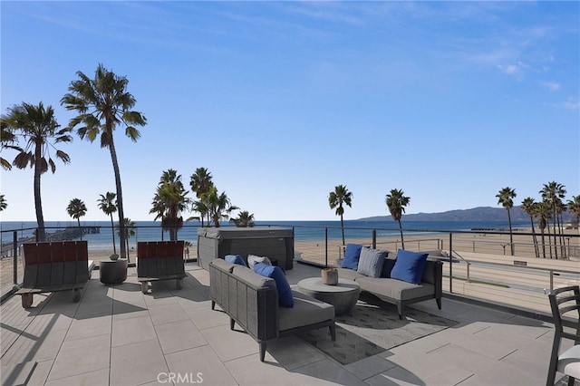 view of patio / terrace with an outdoor hangout area and a water and mountain view