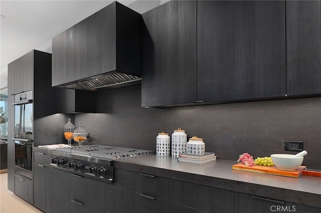 kitchen with tasteful backsplash, stainless steel appliances, and custom range hood