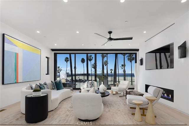 3011 Ocean Front Walk, Venice, CA 90291 - living area with a ceiling fan, recessed lighting, a lit fireplace, and floor to ceiling windows