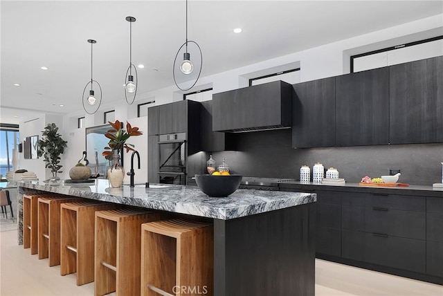 3011 Ocean Front Walk, Venice, CA 90291 - kitchen featuring dark cabinetry, modern cabinets, pendant lighting, and wall chimney exhaust hood