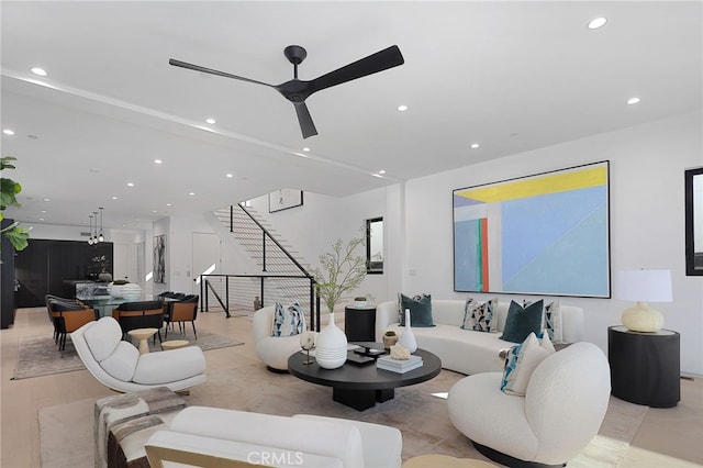 living room with ceiling fan and light hardwood / wood-style floors