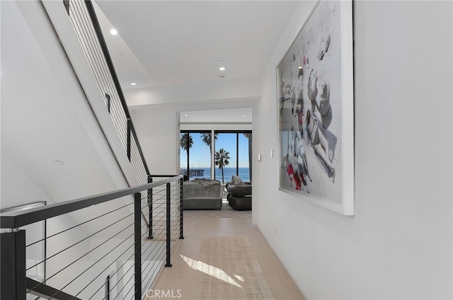 hallway featuring a water view and light wood-type flooring