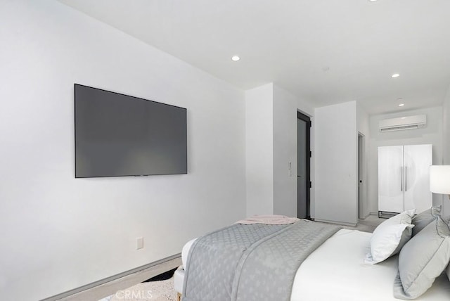 bedroom with white refrigerator and a wall unit AC