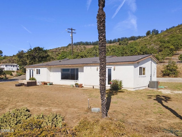 rear view of house featuring outdoor lounge area and central AC unit