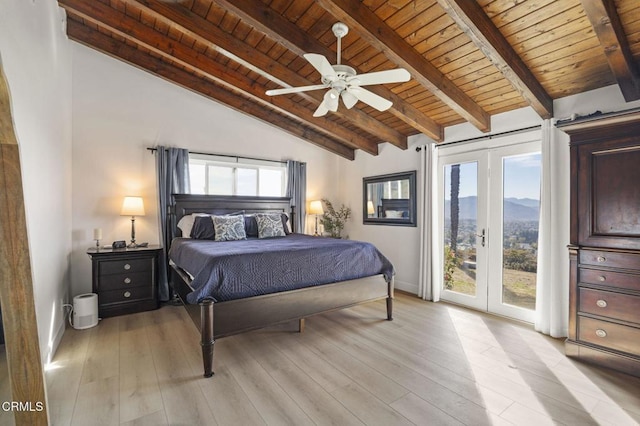 bedroom with vaulted ceiling with beams, access to exterior, ceiling fan, a mountain view, and wooden ceiling