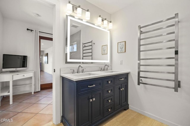 bathroom featuring tile patterned floors, radiator heating unit, and vanity