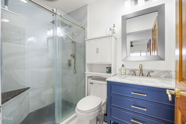 bathroom with ceiling fan, vanity, toilet, and an enclosed shower