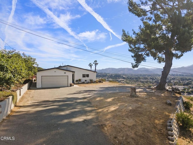 exterior space with a garage, fence, and a mountain view