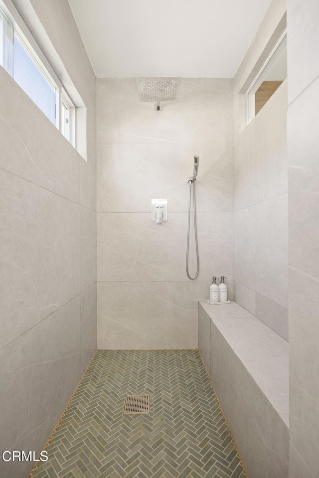 bathroom with a tile shower