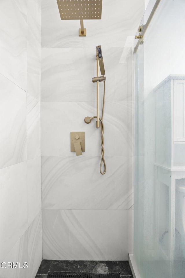 full bath with a marble finish shower