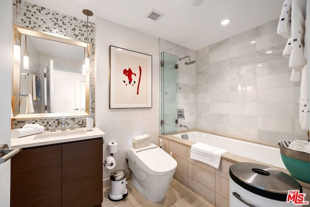 full bathroom with toilet, tiled shower / bath combo, tile patterned floors, and vanity