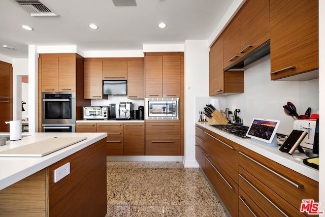 kitchen with stainless steel appliances and extractor fan