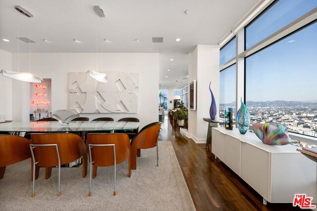 dining room featuring dark wood-type flooring and expansive windows