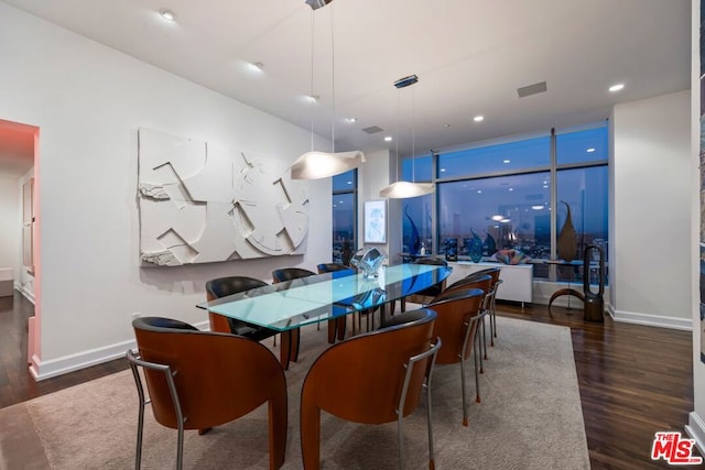 dining area with dark hardwood / wood-style flooring and expansive windows