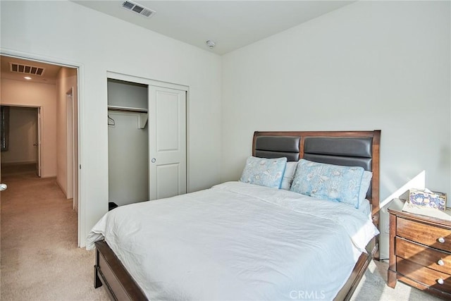 bedroom featuring light colored carpet and a closet