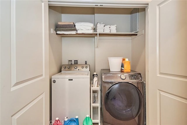 laundry room featuring washing machine and clothes dryer