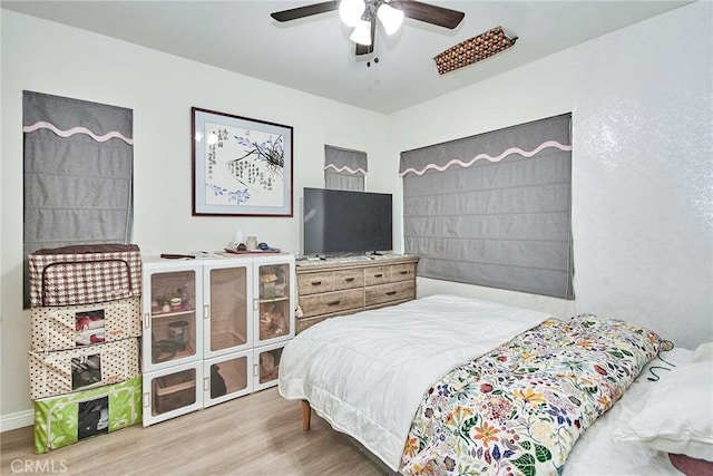 bedroom with hardwood / wood-style flooring and ceiling fan